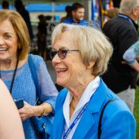 Nancy Lubbers and Donna Brooks speaking with guests at the Jamie Hosford Football Center dedication.